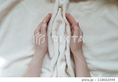 Female hands hugging folds of soft tissue in the shape of the labia, vagina and vulva. The concept of women's intimate health, prevention of gynecological diseases 118682049