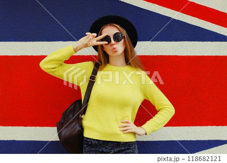 Portrait of beautiful young woman posing on english flag wall background Portrait of beautiful young woman posing on english flag wall background 118682121