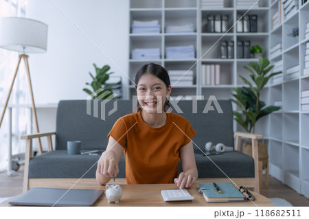 woman creates a detailed financial saving plan using a calculator to organize her expenses and ensure long-term financial stability and security woman creates a detailed financial saving plan using a calculator to organize her expenses and ensure long-term financial stability and security 118682511