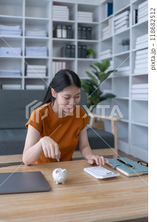 woman creates a detailed financial saving plan using a calculator to organize her expenses and ensure long-term financial stability and security woman creates a detailed financial saving plan using a calculator to organize her expenses and ensure long-term financial stability and security 118682512