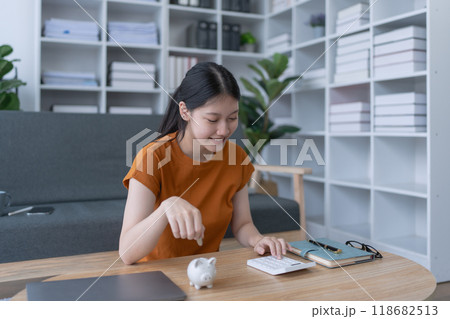 woman creates a detailed financial saving plan using a calculator to organize her expenses and ensure long-term financial stability and security woman creates a detailed financial saving plan using a calculator to organize her expenses and ensure long-term financial stability and security 118682513