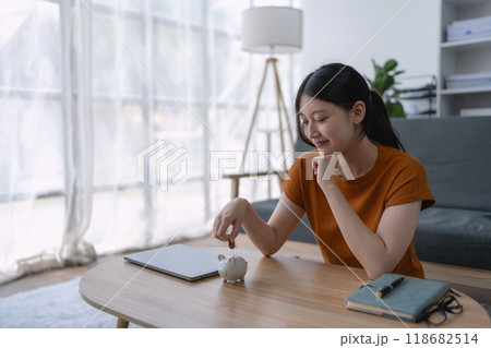 woman carefully develops a financial saving plan, organizing her resources to achieve long-term financial security and stability woman carefully develops a financial saving plan, organizing her resources to achieve long-term financial security and stability 118682514