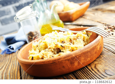 Simple food mashed potatoes with caramelized onions close-up on a plate on the table. 118682612