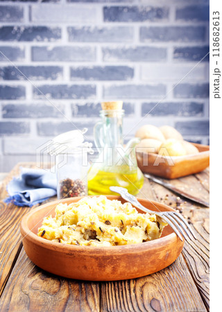 Simple food mashed potatoes with caramelized onions close-up on a plate on the table. 118682613