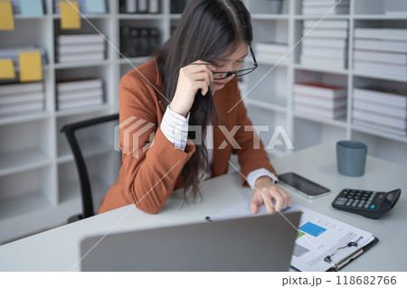 businesswoman plans a finance audit, reviewing documents while battling burnout syndrome. businesswoman plans a finance audit, reviewing documents while battling burnout syndrome. 118682766