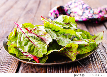 Salad leaves. Raw green leaf vegetables. Mangold leaves on plate 118683125