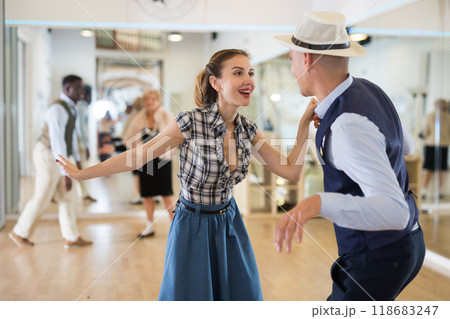 Woman and man dancing swing in studio Woman and man dancing swing in studio 118683247