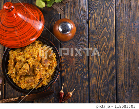 Uzbek cuisine food pilaf, rice with carrots, vegetable oil, raisins 118683503