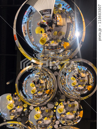 Shimmering Reflections from Spherical Mirrors on a Modern Ceiling. Geometry and Light Creates a Captivating Artistic Display in a Public Space. 118683807