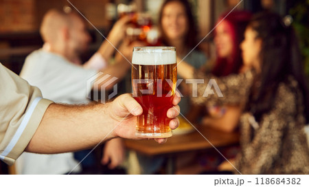 Together, they toast to every goal, every triumph, and every unforgettable moment that makes being sport fan so thrilling. Selective focus. Together, they toast to every goal, every triumph, and every unforgettable moment that makes being sport fan so thrilling. Selective focus. 118684382