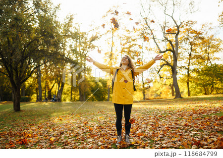 Hiking in autumn forest. Tourist walks through autumn park in sunny weather. Adventure concept. Hiking in autumn forest. Tourist walks through autumn park in sunny weather. Adventure concept. 118684799