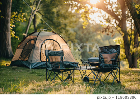 Camping outdoors with lots of sunlight. tent, chairs, a tent BBQ rack, and more 118685886