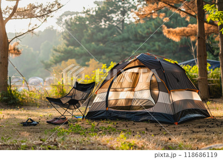 Camping outdoors with lots of sunlight. tent, chairs, a tent BBQ rack, and more 118686119