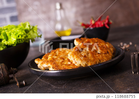 Roasted chicken cutlets on black plate Roasted chicken cutlets on black plate 118688755