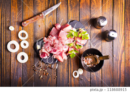 Raw meat shish kebab skewers. Wooden background. Raw meat shish kebab skewers. Wooden background. 118688915