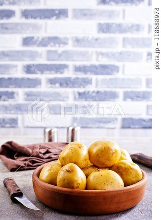 bowl with raw potatoes on a table bowl with raw potatoes on a table 118688978