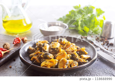 spicy stir fried mussel with slice onion and spice on plate 118688990