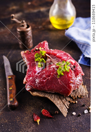 Raw meat with herbs and garlic, marble meat. Wooden background. Top view. 118689415