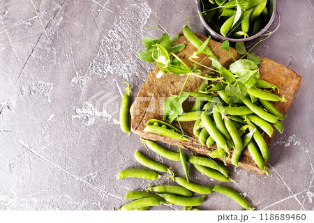 Pods of green peas with leaves. Fresh food background. Top view 118689460