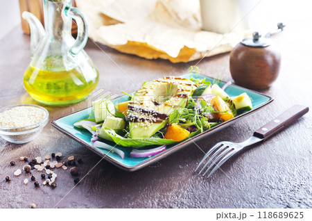 Fresh salad with avocado in a bowl. Healthy vegetarian dish Fresh salad with avocado in a bowl. Healthy vegetarian dish 118689625