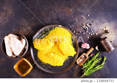 chicken wings with panko in a gray ceramic bowl on a rustic table ready to cooking 118689731