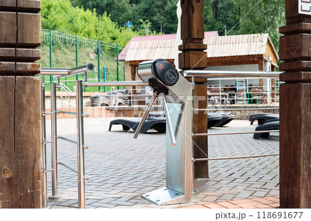 Entrance turnstile gate at swimming pool area on a sunny day. Entrance turnstile gate at swimming pool area on a sunny day. 118691677