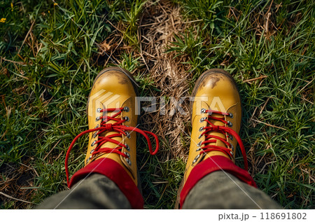 View from above of boots walking on an autumn path. Fall season, first person perspective. AI Generated 118691802