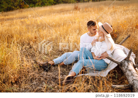 Young couple having fun walking and hugging n the park. Autumn weather. Relaxation, youth. Young couple having fun walking and hugging n the park. Autumn weather. Relaxation, youth. 118692019