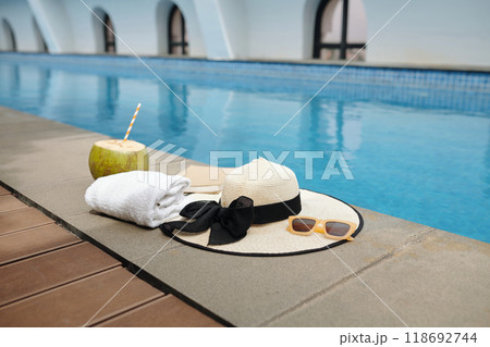 Relaxing by Swimming Pool with Refreshment Drink 118692744