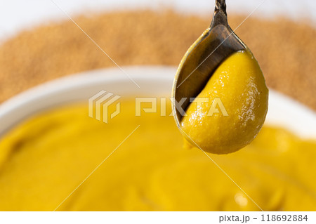 Traditional spicy mustard sauce in a spoon, space for text Traditional spicy mustard sauce in a spoon, space for text 118692884