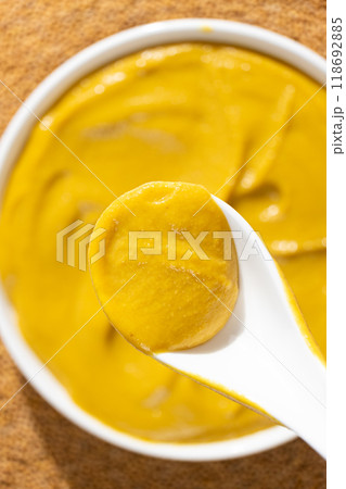 Traditional spicy mustard sauce in a spoon close-up. Traditional spicy mustard sauce in a spoon close-up. 118692885