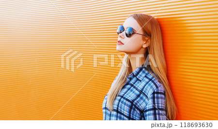 Fashion portrait beautiful blonde woman on a colorful orange background empty copy space Fashion portrait beautiful blonde woman on a colorful orange background empty copy space 118693630