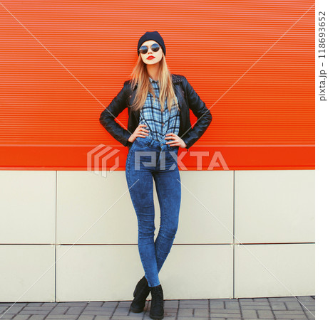 Fashion pretty blonde woman posing in rock black style over red colorful background 118693652
