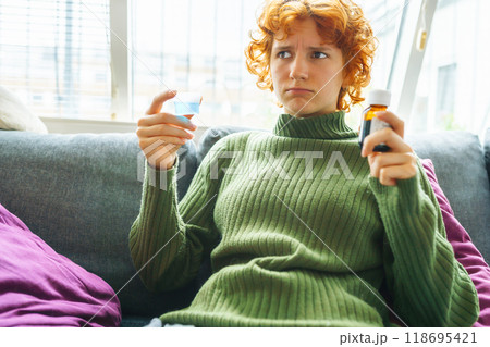 portrait of a young woman with a cold 118695421