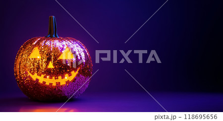 Halloween pumpkin decorating sequined, jack o lantern with carved scary face, sparkling decoration for the holiday on dark purple background 118695656