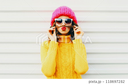 Fashion portrait funny young woman shows mustache hair blowing kiss having fun over white background 118697282