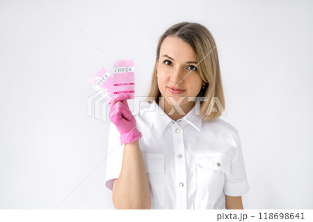 A female gynecologist in pink latex gloves holds pregnancy tests in hand A female gynecologist in pink latex gloves holds pregnancy tests in hand 118698641
