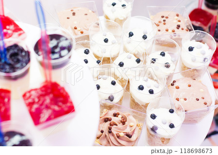 Candy bar at celebration party. Wedding table with sweets, cake, pastries, muffins, sugar treats. 118698673