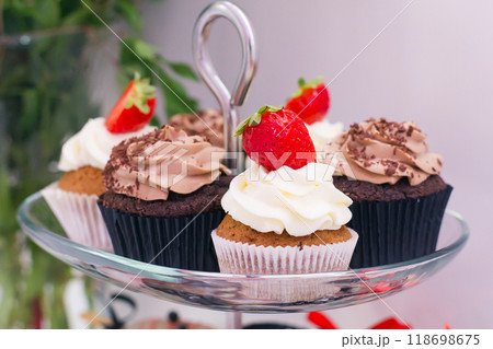 Candy bar at celebration party. Close up of sweets, cakes, pastries, muffins with strawberries. Candy bar at celebration party. Close up of sweets, cakes, pastries, muffins with strawberries. 118698675