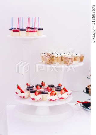 Candy bar at celebration party. Wedding table with sweets, cake, pastries, muffins, sugar treats. 118698678