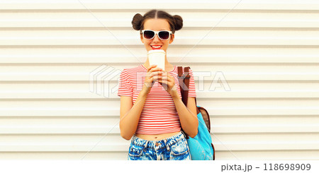 Portrait of happy smiling young woman drinking coffee with cool hairstyle on white background 118698909