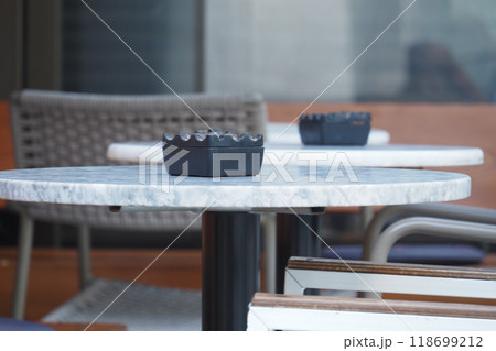 An Elegant Outdoor Dining Space Features a Beautiful Marble Table Accompanied by Stylish Chairs An Elegant Outdoor Dining Space Features a Beautiful Marble Table Accompanied by Stylish Chairs 118699212