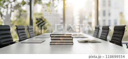 A table with a stack of books and a potted plant in front of a window by AI generated image 118699554