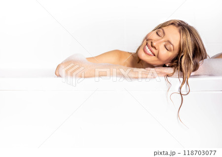 Woman Lying In Bathtub With Foam While Relaxing In Luxury Bathroom At Home, Happy Young Female  118703077