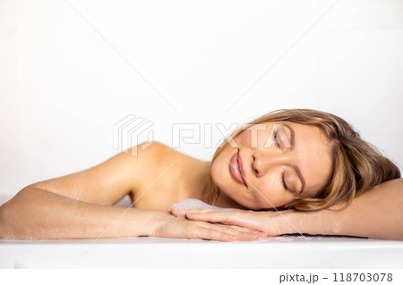 A young, beautiful, smiling, sexy and happy woman with long hair takes a bath with foam A young, beautiful, smiling, sexy and happy woman with long hair takes a bath with foam 118703078