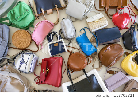 Fashionable multi-colored trendy women's bags on a white background. Fashion and beauty concept. Fashionable multi-colored trendy women's bags on a white background. Fashion and beauty concept. 118703821