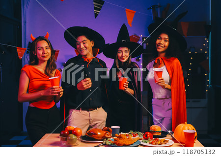 Joyful office Halloween party with coworkers in costumes, celebrating with drinks and laughter, fostering teamwork and festive spirit 118705132