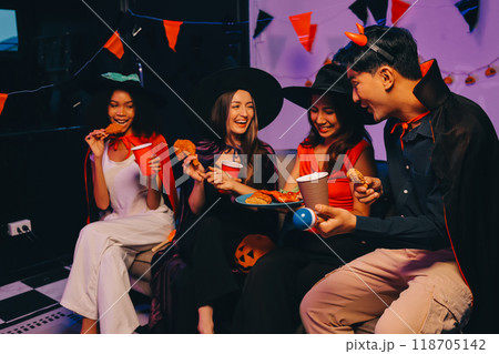 Joyful office Halloween party with coworkers in costumes, celebrating with drinks and laughter, fostering teamwork and festive spirit 118705142