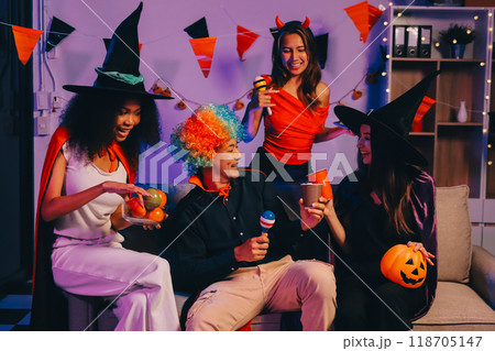 Joyful office Halloween party with coworkers in costumes, celebrating with drinks and laughter, fostering teamwork and festive spirit 118705147