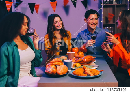 Joyful office Halloween party with coworkers in costumes, celebrating with drinks and laughter, fostering teamwork and festive spirit 118705191